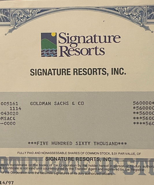 Vintage Signature Resorts stock certificate with logo, ornate border, and "560,000" shares printed in blue and tan color