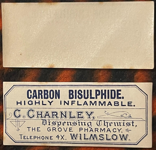 Vintage pharmacy label for Carbon Bisulphide from C. Charnley, The Grove Pharmacy, Wilmslow, printed in dark blue text on cre