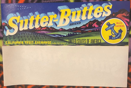 Vintage Sutter-Buttes fruit crate label with blue mountains, yellow text, and California Fruit Exchange logo on blank cardboa