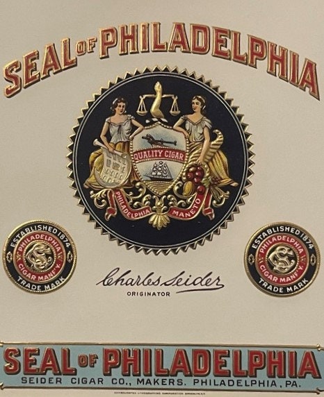 Vintage Seal of Philadelphia cigar label with gold lettering, central coat of arms with scales and figures, two smaller circu