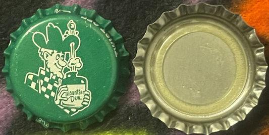 Green and cream bottle caps shown front and back, green cap features Willy the Hillbilly character and Mountain Dew branding