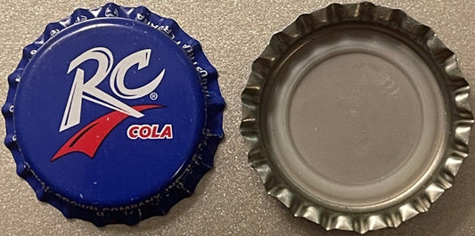 Front and back of vintage RC Cola bottle cap with blue crown-ridged design and white RC logo with red swoosh on tan surface