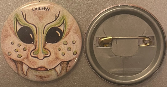 Front and back of a pinback button featuring "EVILEEN" text and an illustrated fanged green cat face with large black eyes on