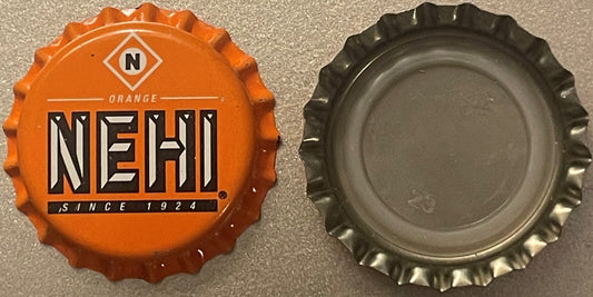 Vintage Nehi Orange bottle cap showing front and back views, orange with black and white NEHI logo and "SINCE 1924" text, dis