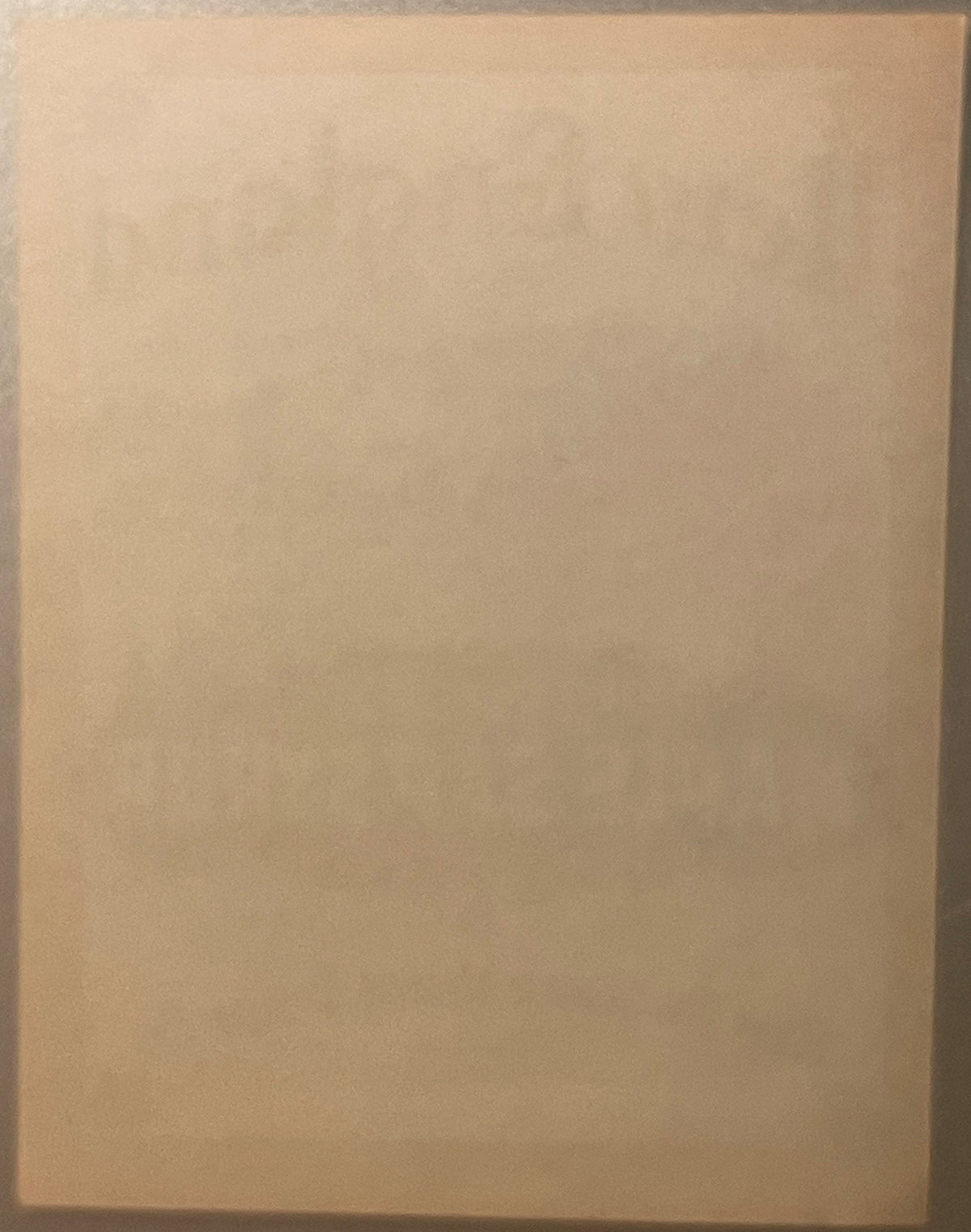 Blank cream-colored vintage label with subtle aging, photographed flat against plain background