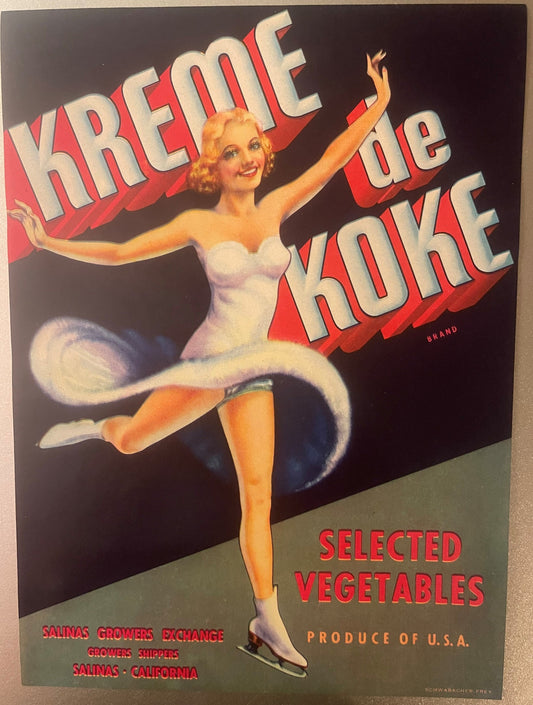 Vintage vegetable crate label featuring blonde ice skater in white costume with red "Kreme De Koke" text on dark background,