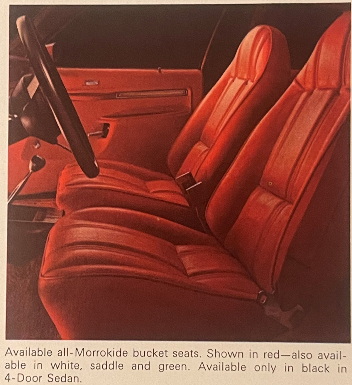 Bright red bucket seats and door panel interior of vintage car, with text describing Morrokide seat options in red, white