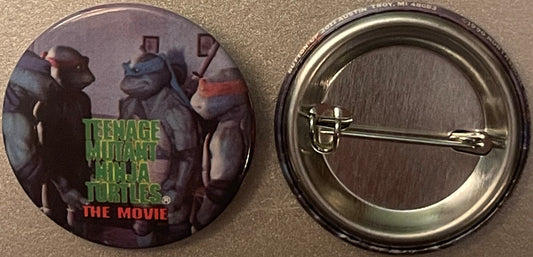 Front and back of a circular pinback button featuring three TMNT characters in ninja poses with "TEENAGE MUTANT NINJA TURTLES