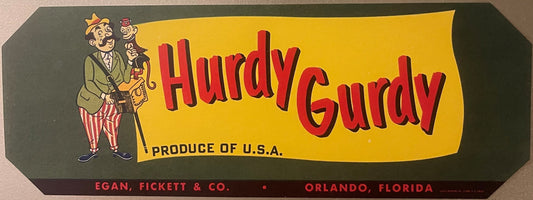 Vintage fruit crate label with cheerful man in striped pants holding monkey, red "Hurdy Gurdy" text on yellow background, "Pr