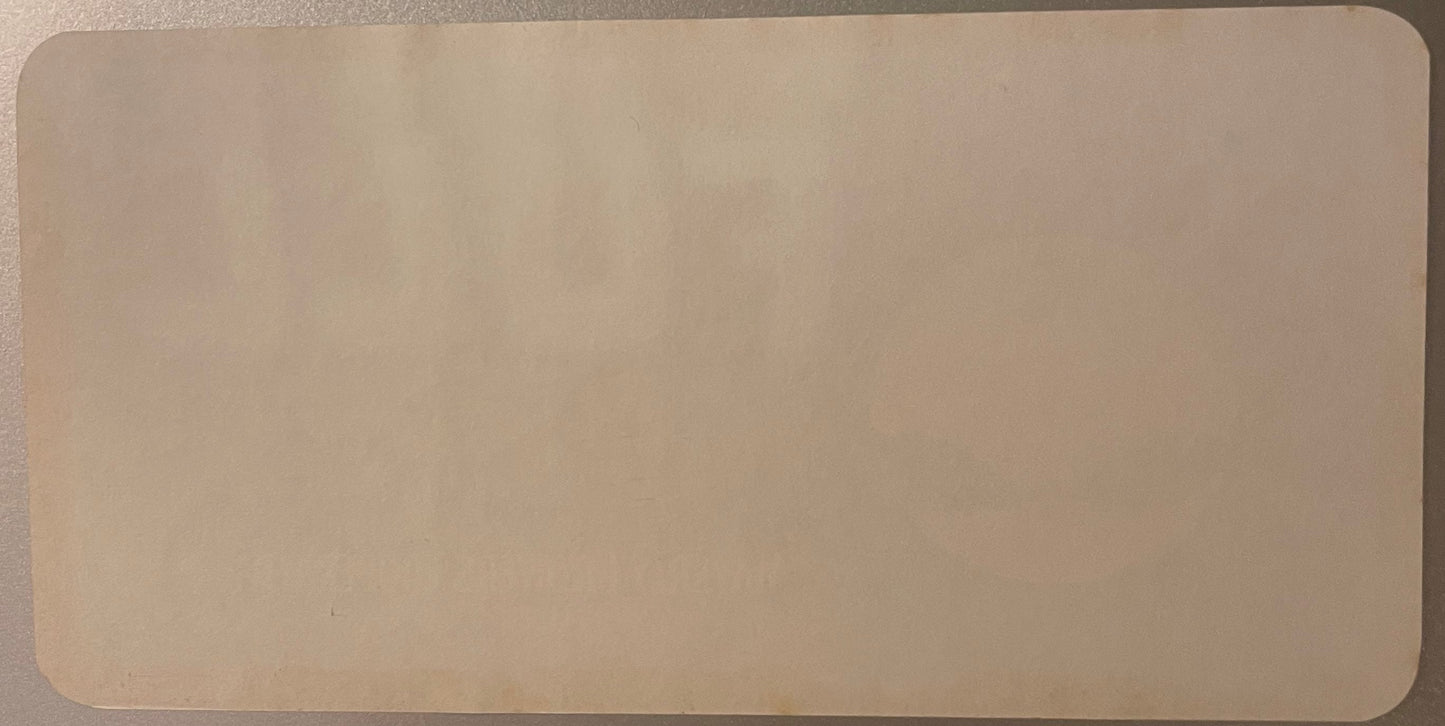 Blank cream-colored vintage crate label with rounded corners, shown flat against gray surface