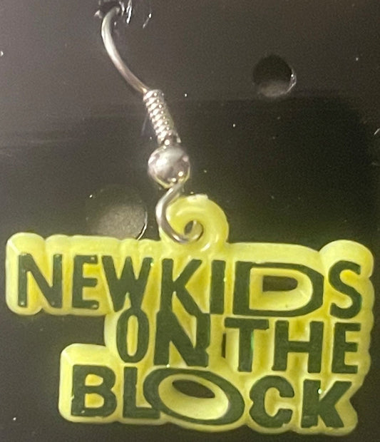 Yellow plastic charm earring with silver hook displayed against dark background, text reads "NEW KIDS ON THE BLOCK