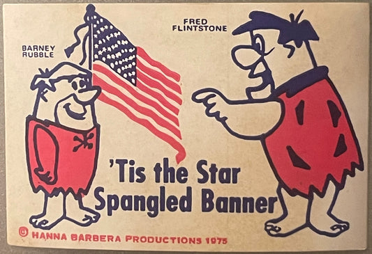 Vintage 1975 Hanna Barbera sticker sheet featuring Barney Rubble and Fred Flintstone holding an American flag with "Tis the S
