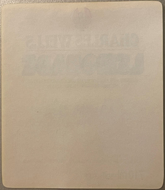 Blank cream-colored page or label backing with rounded corners, shown flat against textured surface