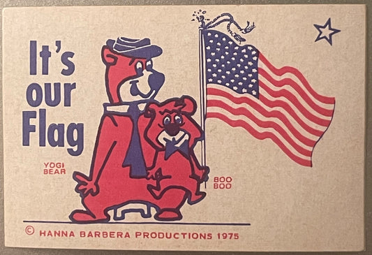 Vintage 1975 Hanna-Barbera sticker featuring Yogi Bear and Boo Boo in red holding American flag, beige background