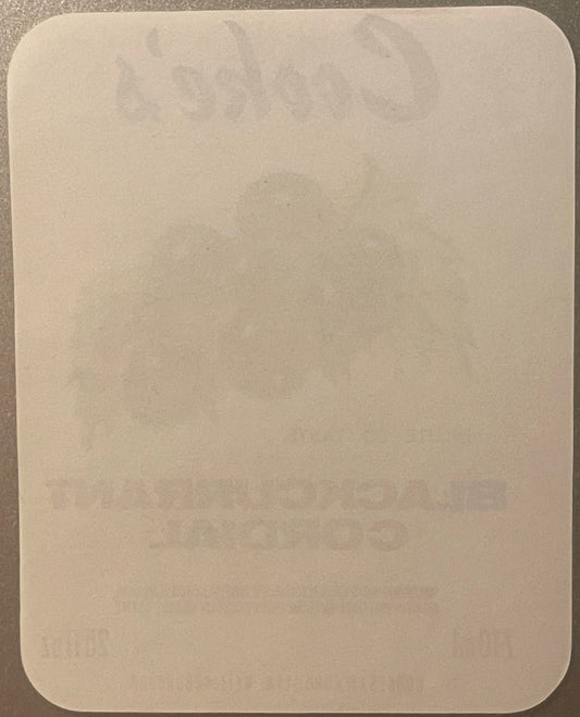 Blank cream-colored rectangular label with rounded corners on gray background, showing faint watermark or design impression