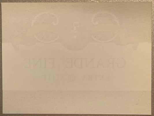 Back of the Grande Fine spirits label: plain paper with the front design and lettering showing faintly through in reverse