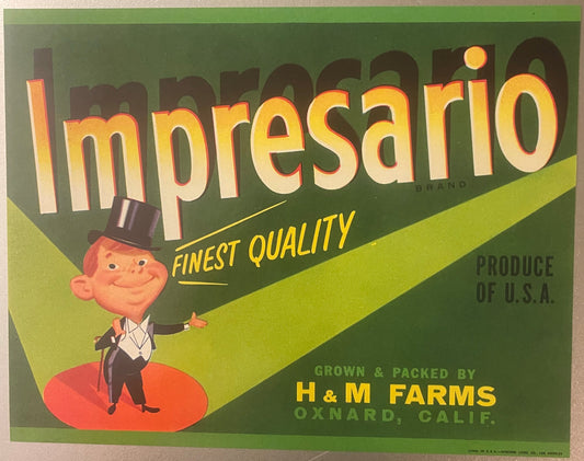 Vintage Impresario fruit crate label featuring a smiling man in top hat and tuxedo on red oval, yellow and green background,