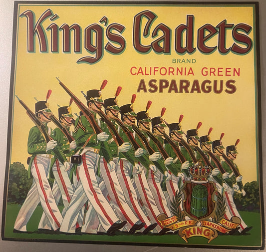Vintage King's Cadets asparagus crate label featuring marching soldiers in green uniforms with rifles on yellow background, C