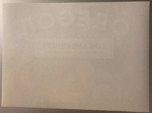Blank cream-colored vintage crate label on gray surface, text too faded to read clearly