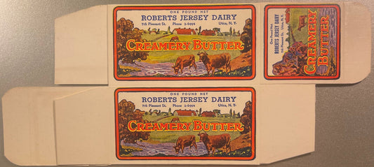 Unfolded vintage butter box with two identical pastoral labels showing cows by water, "Roberts Jersey Dairy Creamery Butter"