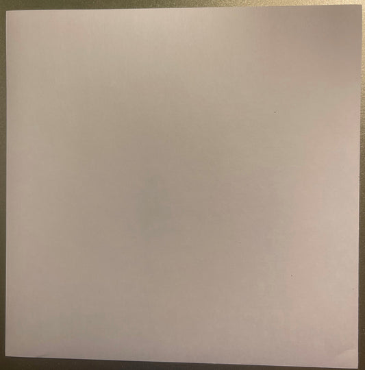 Blank pale pink translucent rectangular sheet on textured surface, photographed flat from above