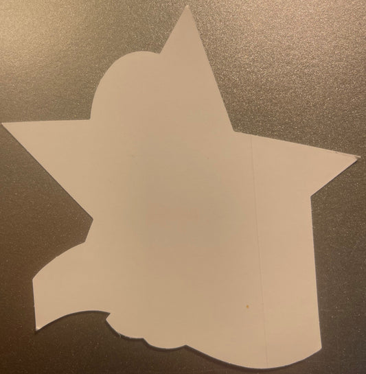 Cream-colored star-shaped sticker on gold glittery background, shown flat from above