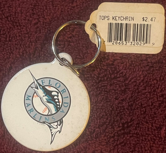 Cream-colored round keychain with Florida Marlins logo featuring a marlin fish, attached price tag reading "TOPS KEYCHAIN $2.