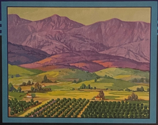 Vintage lemon crate label featuring rolling green farmland with orchards below purple mountains under golden sky, framed in t