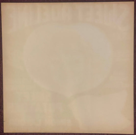 Blank cream-colored antique crate label with dark brown border, showing age-related discoloration and wear marks