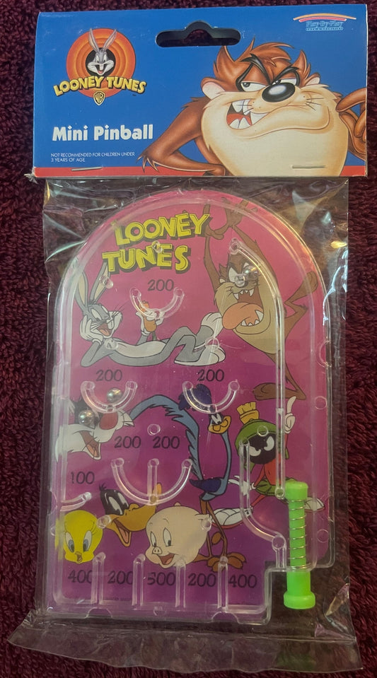 Vintage Looney Tunes mini pinball game in pink packaging showing Bugs Bunny, Road Runner, Tasmanian Devil and other character