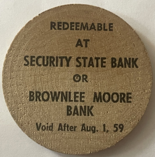 Tan wooden nickel with embossed text reading "REDEEMABLE AT SECURITY STATE BANK OR BROWNLEE MOORE BANK Void After Aug. 1, 59