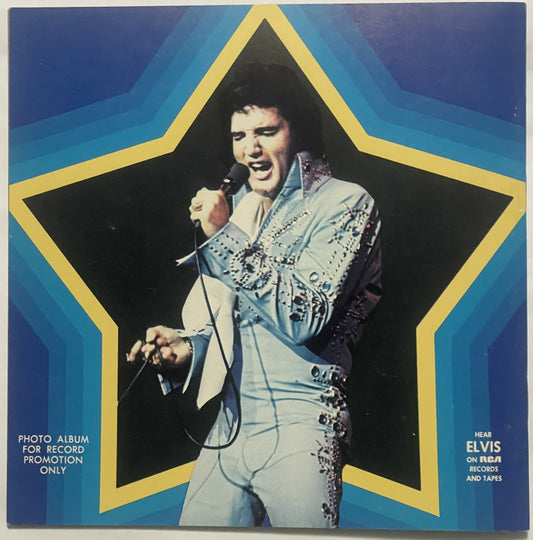 Vintage 1970s promotional photo album cover featuring performer in jeweled white jumpsuit singing into microphone against blu