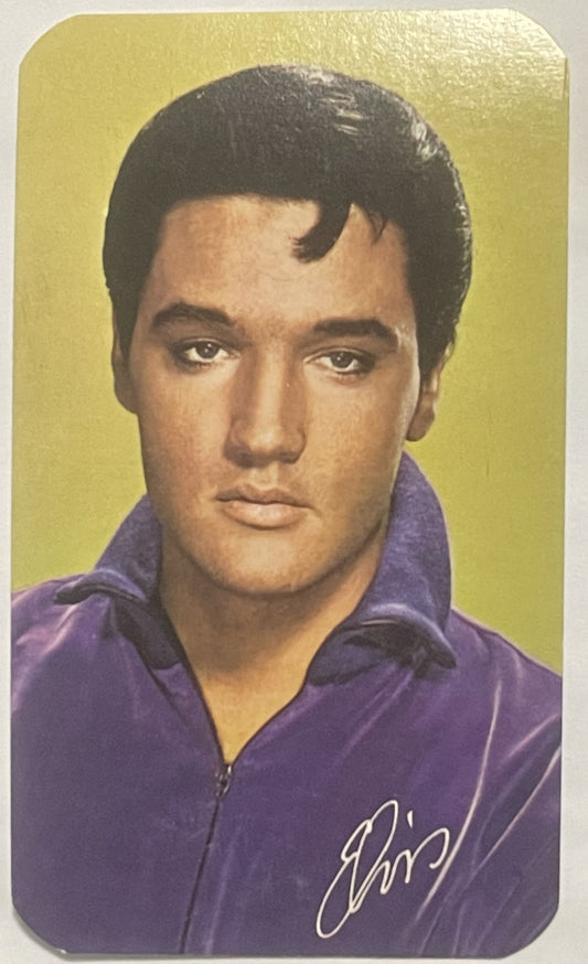 Vintage pocket calendar card featuring a man in purple shirt against yellow background with cursive signature, front view por
