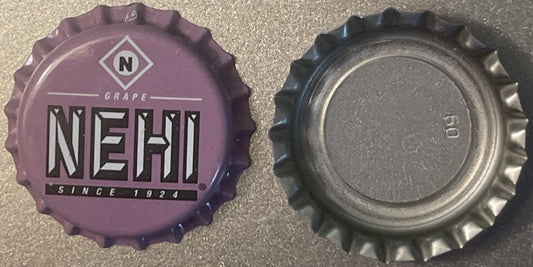 Purple Nehi grape soda bottle cap from 1924 shown front and back, displaying embossed text and diamond logo on cork-lined cro