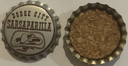Vintage Dodge City Sarsaparilla bottle cap shown front and back, metal with embossed Western hat design and cork liner visibl