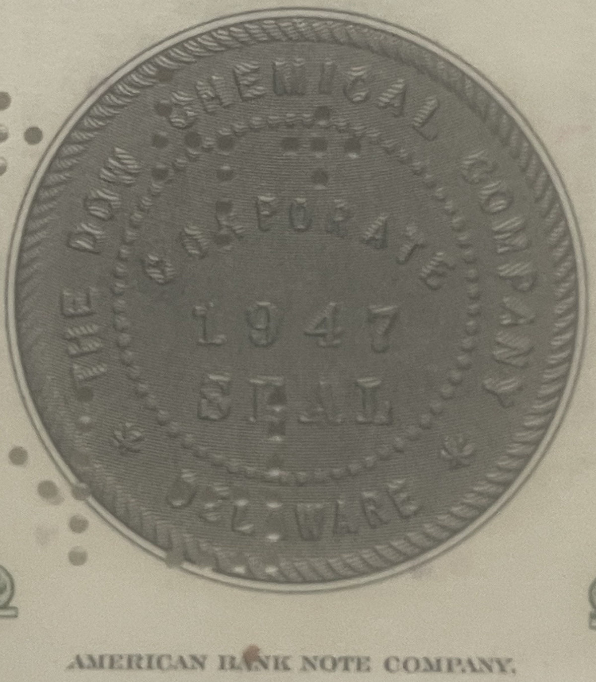 Close-up of the embossed Dow Chemical Company corporate seal, dated 1947, Delaware, with the American Bank Note Company imprint below