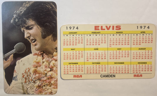 Vintage 1974 Elvis calendar card showing signed photo of performer at microphone and RCA Camden 12-month calendar grid in yel