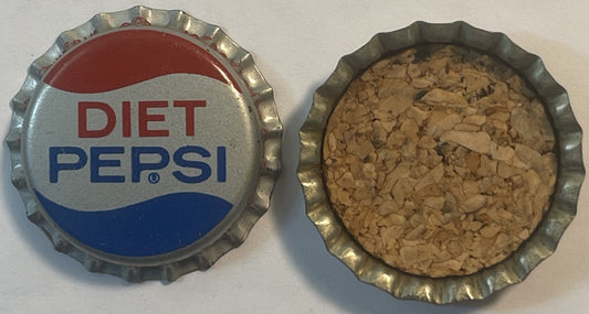 Vintage Diet Pepsi bottle cap showing front and back views with red, white and blue branding and cork lining visible inside.