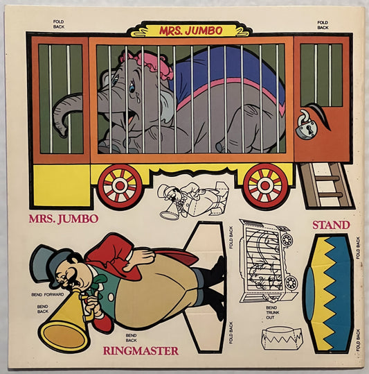 Unfolded vintage Dumbo press-out book page showing Mrs. Jumbo circus wagon, Ringmaster figure, and stand components with fold