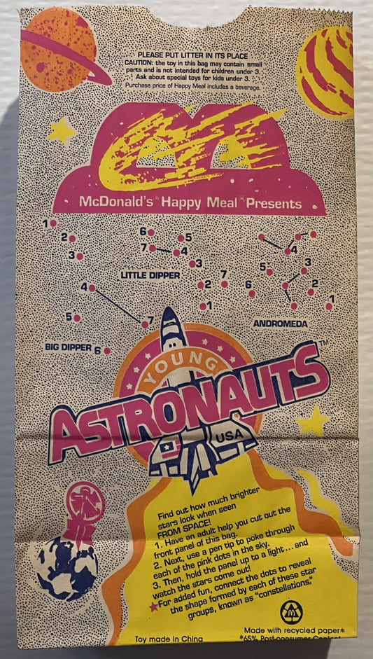 Vintage McDonald's Happy Meal bag featuring Young Astronauts space theme with colorful planets, rocket, and connect-the-dots