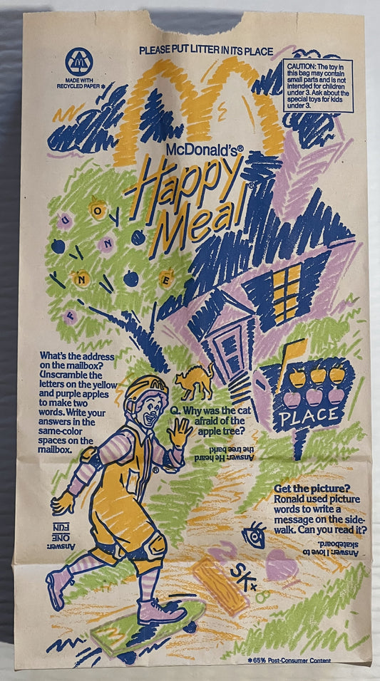 Vintage McDonald's Happy Meal bag with Ronald McDonald illustration, colorful house and trees, interactive puzzles and games