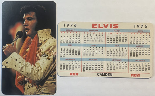 Vintage 1976 Elvis Presley calendar card showing performer in gold jumpsuit with microphone and signed autograph, with RCA Ca