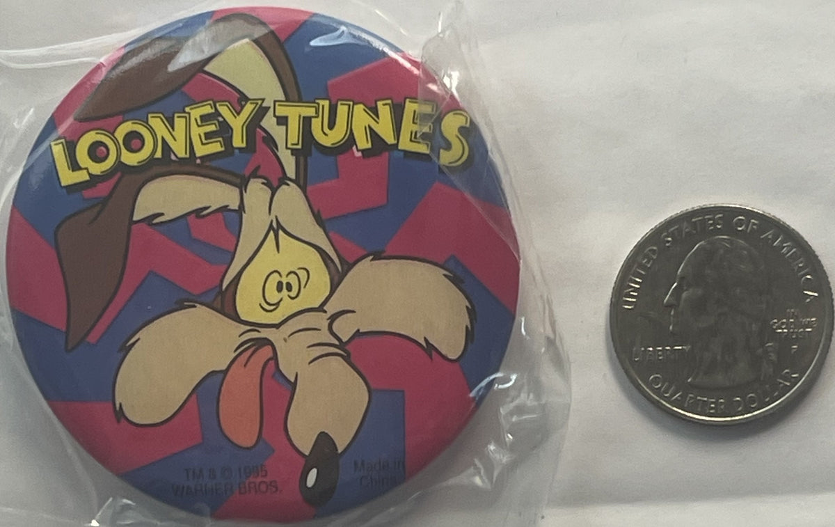 Unopened Looney Tunes pin featuring Wile E. Coyote in tan and red on blue and red checkered background, shown next to a quart