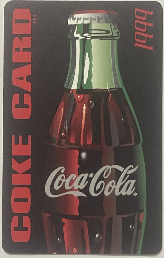 Vintage Coca-Cola credit card featuring a classic glass bottle with green and red label against dark background, red "COKE CA