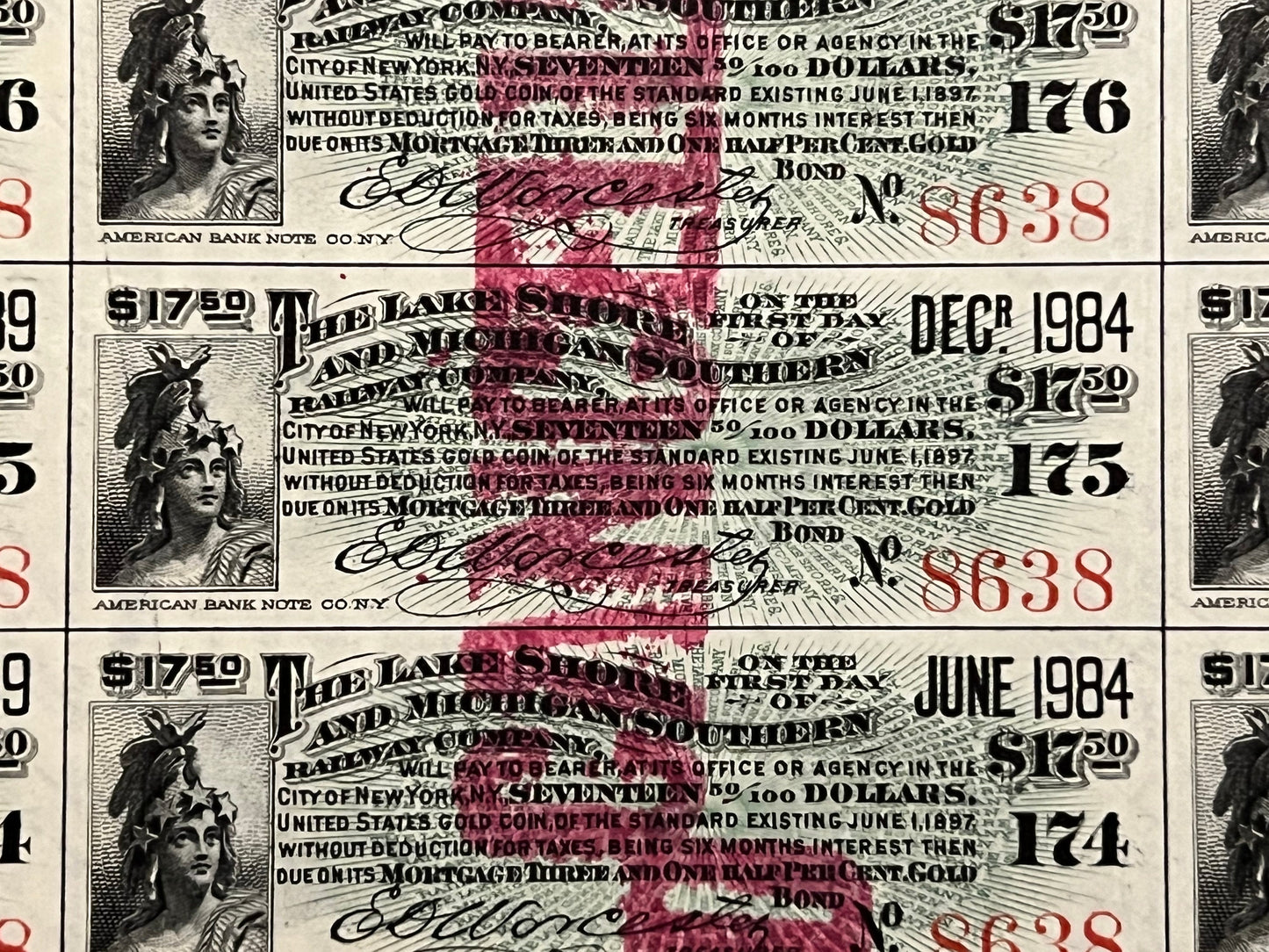 Three overlapping antique railroad bond certificates with engraved female portrait, ornate text, red stamps and handwritten s