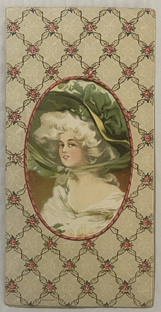 Antique chromolithograph insert featuring a pale-skinned woman in white dress and green bonnet with yellow ribbon, centered i