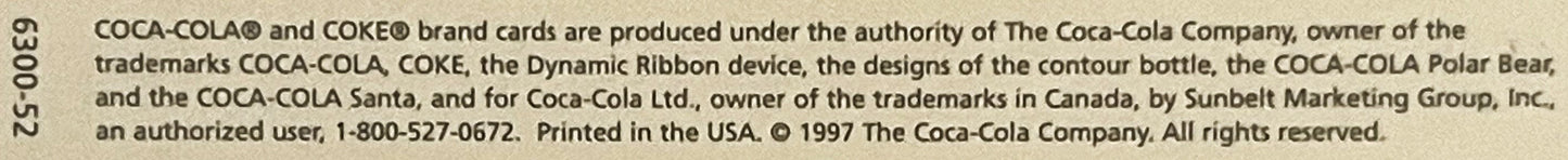 Close-up of copyright text from 1997 Coca-Cola postcard showing trademark and printing information on beige background