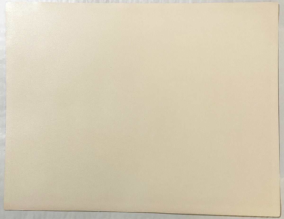 Blank cream-colored page or backing of a vintage art print, shown flat against gray surface