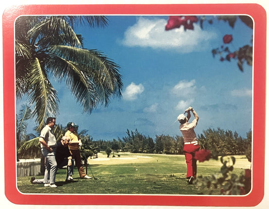 Vintage golf postcard with red border showing golfer mid-swing in tropical setting with palm tree, spectators, and pine trees
