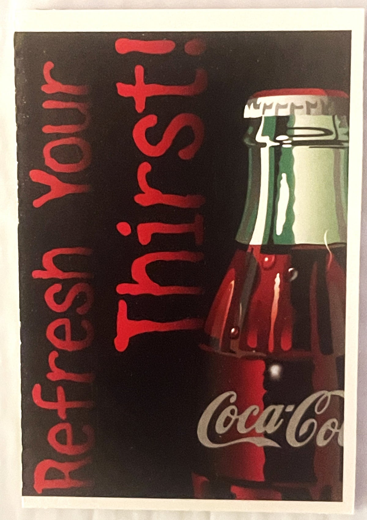 Vintage Coca-Cola promotional card with red text reading "Refresh+Fruit" on black background, bottle image on right side